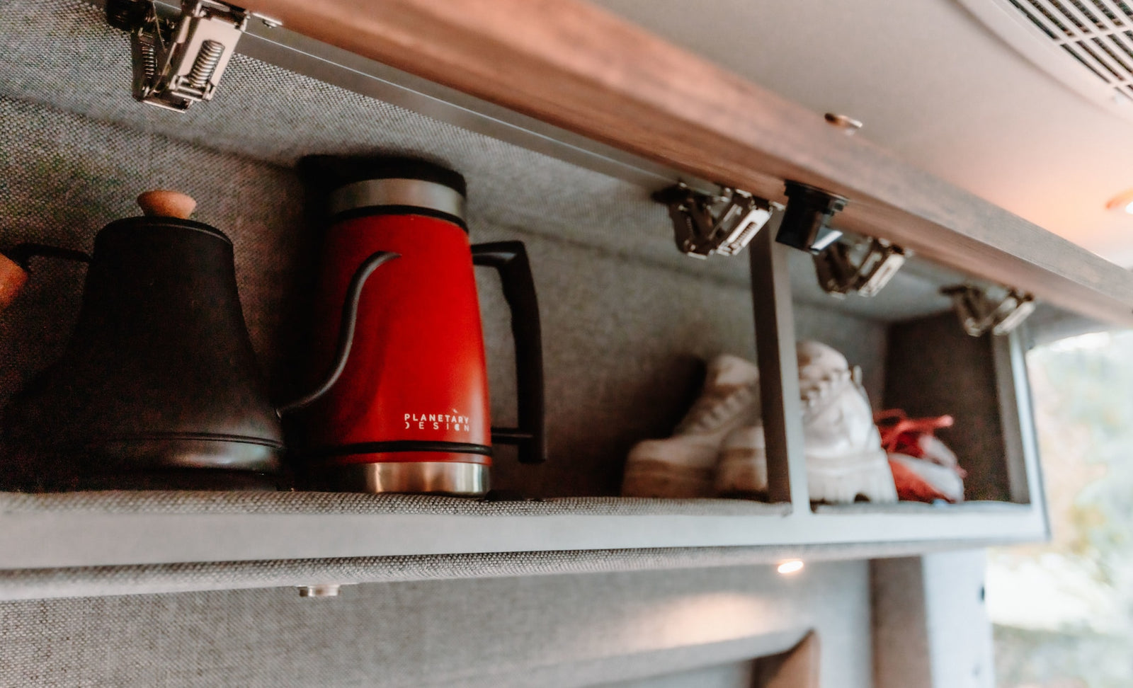 and a cozy bed with a soft blanket.|Comfortable RV rental interior features a cozy bed