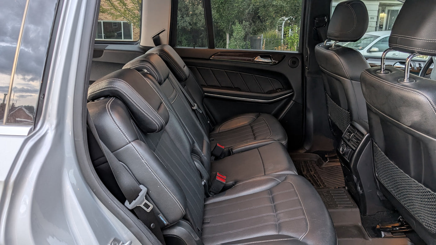 Spacious rear leather seats in this rental SUV, perfect for your next RV rental alternative trip.