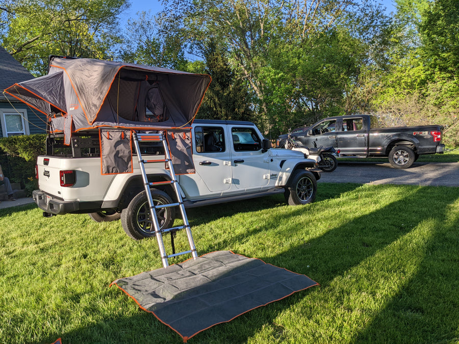 perfect for an rv rental adventure & camping.|White Jeep Gladiator showcasing a deployed Roofnest rooftop tent for outdoor camping. Perfect as an RV rental alternative.