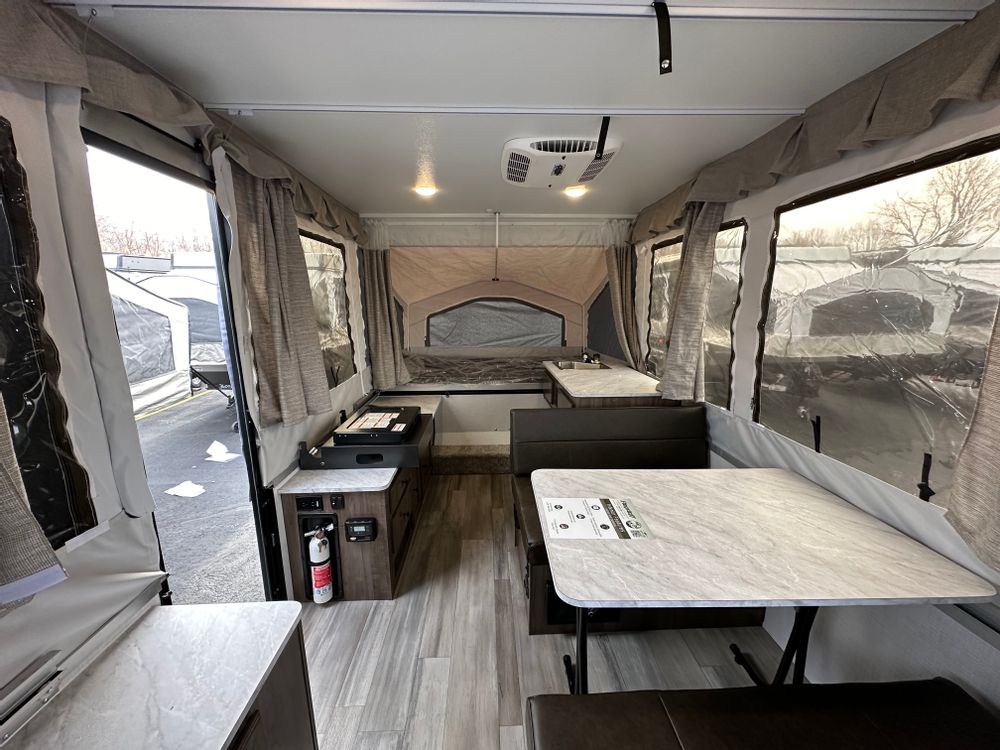 and an exterior grill setup.|Gray Flagstaff pop-up camper