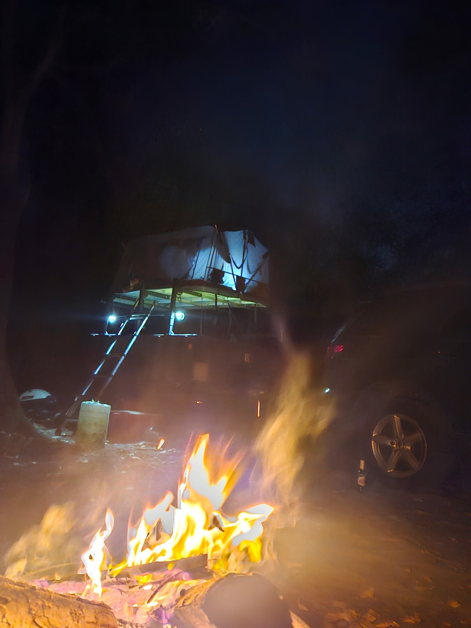 rooftop tent & awning. Great for an RV rental adventure in the woods.|Night adventure camping with an RV rental alternative: a rooftop tent on a trailer