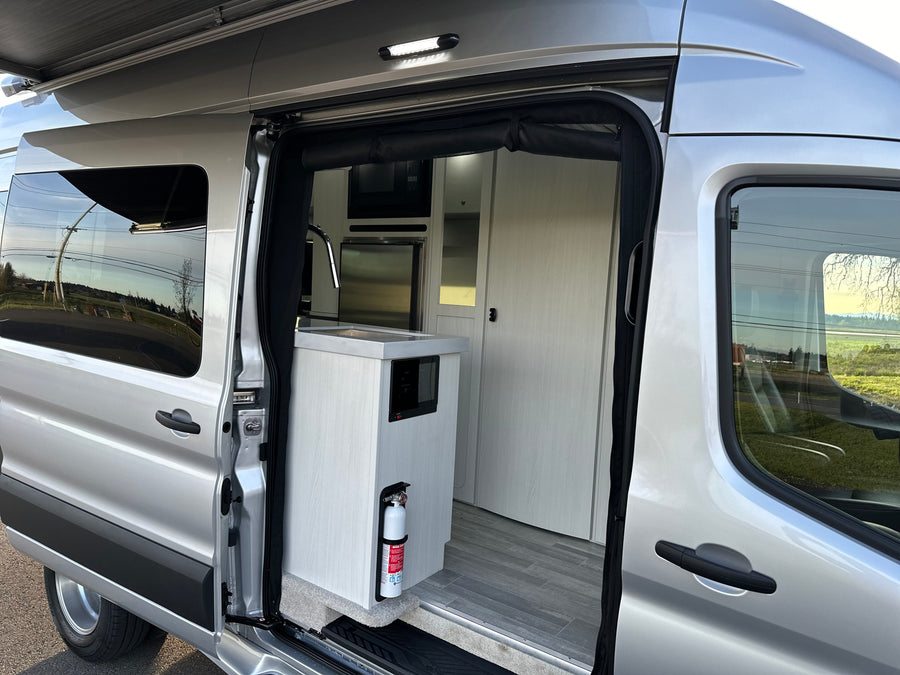 Explore comfort in this modern rv rental camper van interior, featuring a compact kitchen & ample storage.