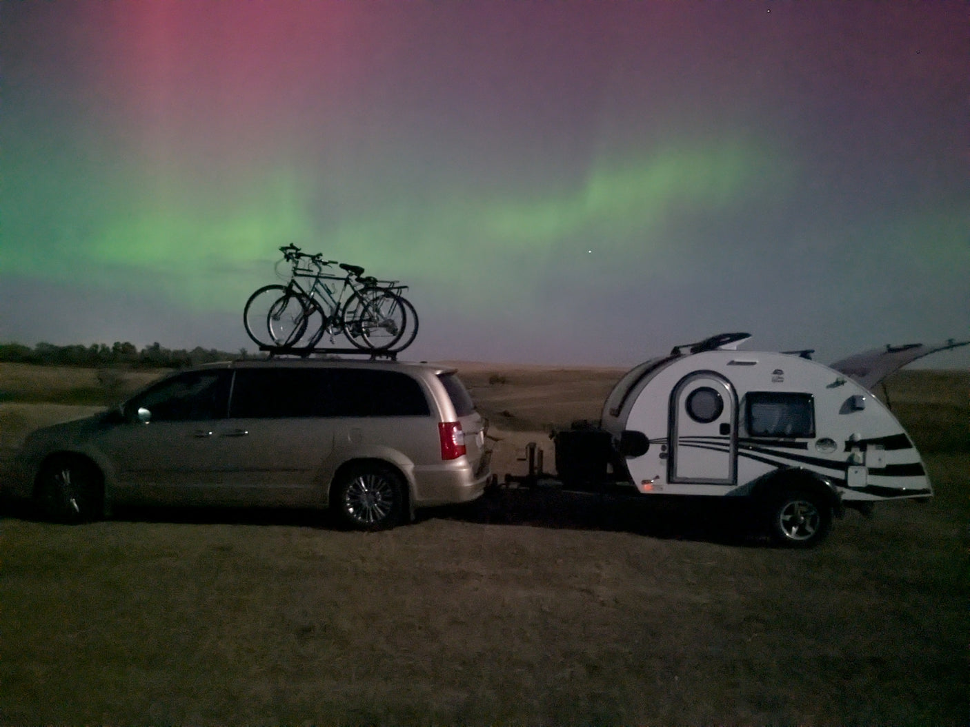 An RV rental, minivan & bikes beneath the stunning Northern Lights. An unforgettable camping experience!