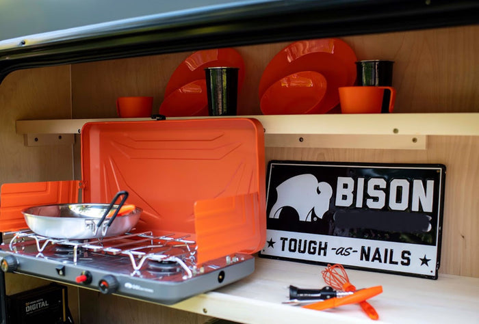 ideal for camping adventures.|Get ready for adventure with an RV rental! This camping trailer's open rear reveals organized storage: cooler