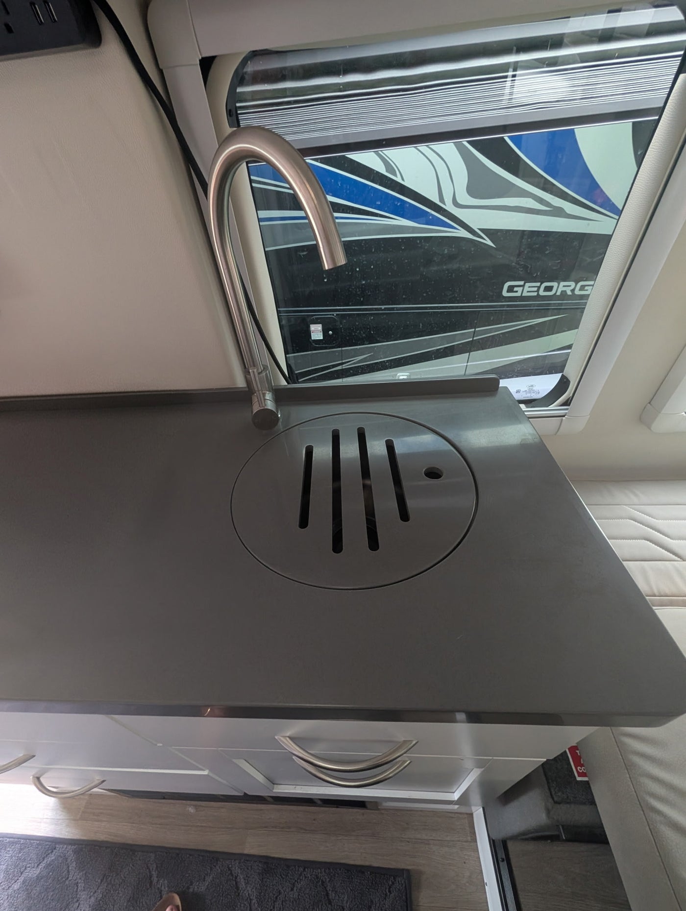 and shower.|RV rental interior with compact kitchenette (sink — photo 12