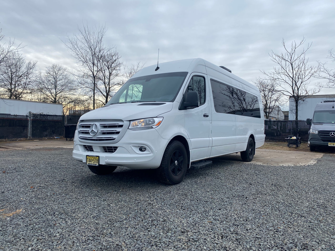 A clean white Mercedes-Benz Sprinter van on gravel. Great for RV rental & road trips in New Jersey.