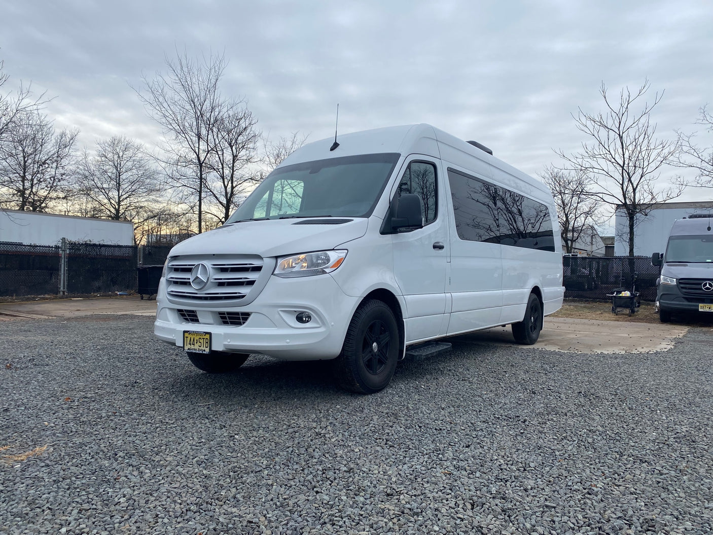 A clean white Mercedes-Benz Sprinter van on gravel. Great for RV rental & road trips in New Jersey.