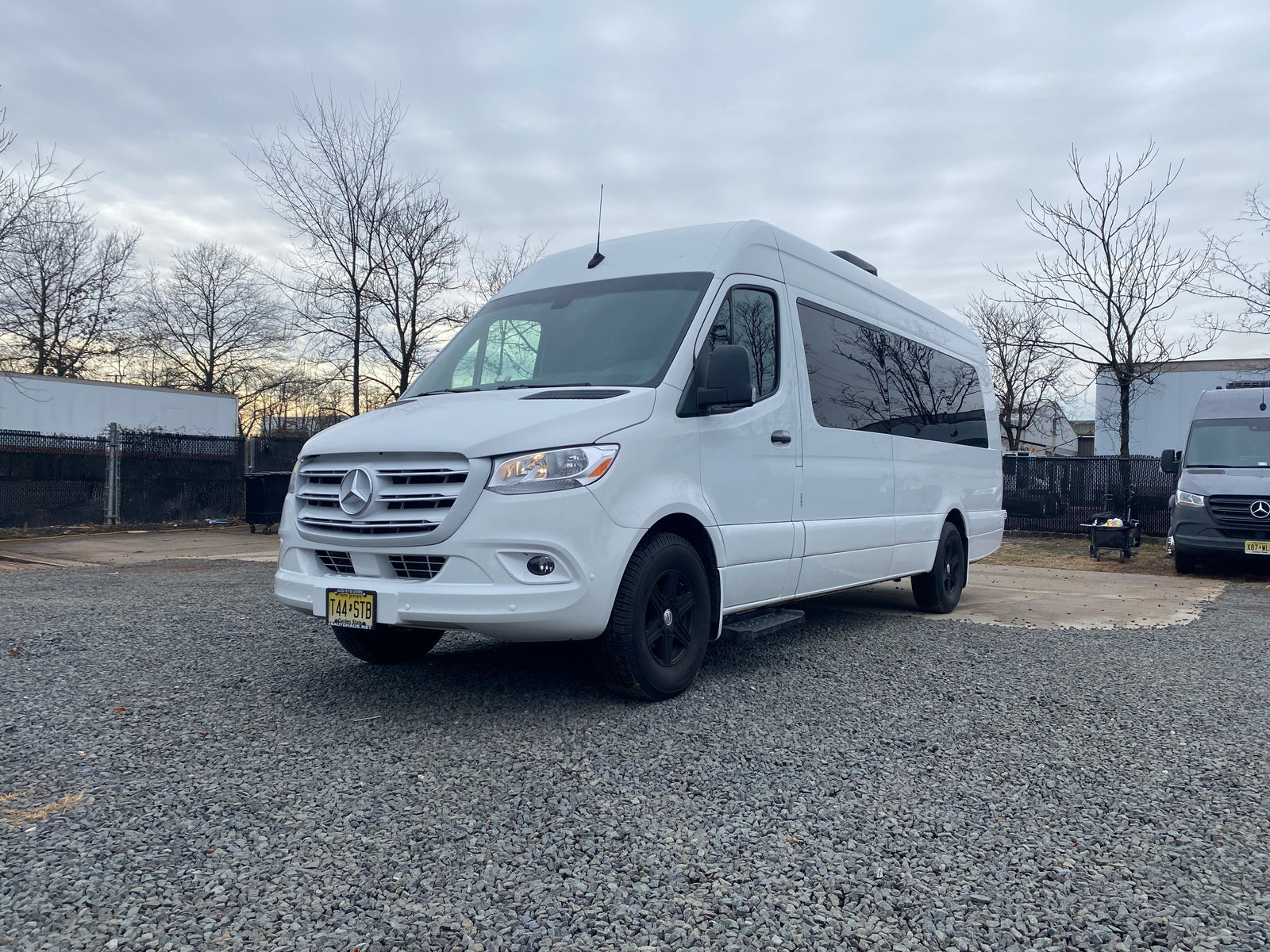 A clean white Mercedes-Benz Sprinter van on gravel. Great for RV rental & road trips in New Jersey.