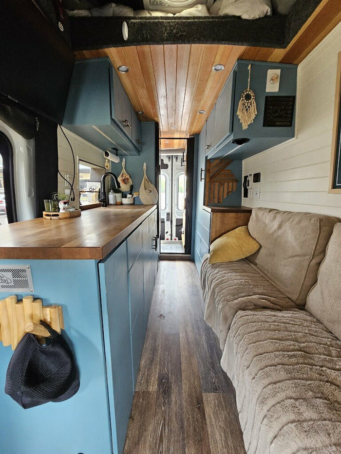compact living space.|Step inside this cozy RV rental: a modern kitchen with wood counters