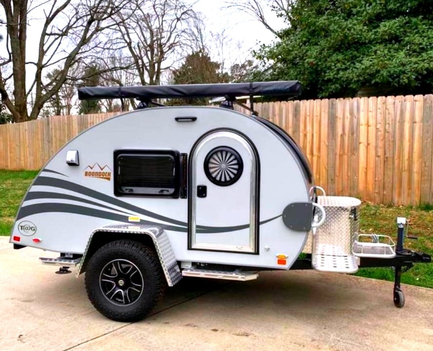 A light gray nuCamp T@G Boondock teardrop rv rental, ready for off-grid camping adventures.