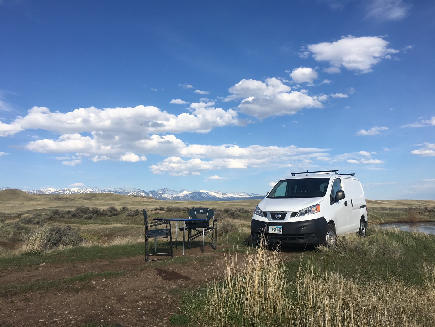 White Nissan van with chairs/table set up