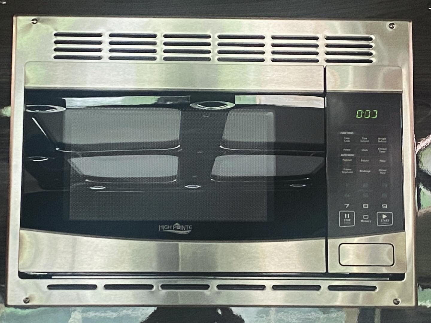 revealing a spacious beige custom interior and tow hitch.|Luxury RV rental features a built-in entertainment system with a large screen displaying numerous streaming apps and gaming options.|RV rental's luxurious interior: cream quilted leather seats