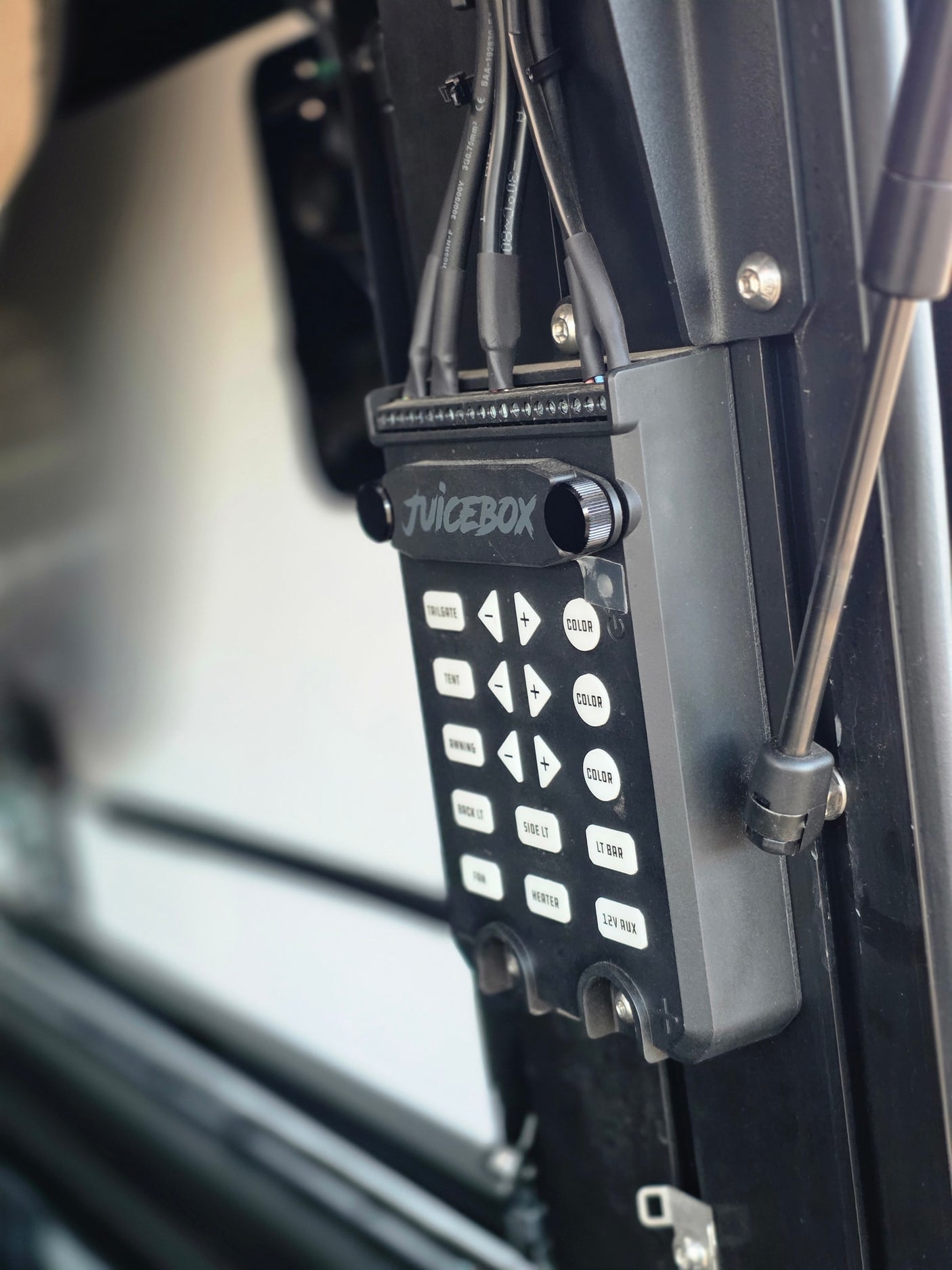 Juicebox RV control panel in an RV rental, managing essential functions like tailgate, tent, awning, lights, and heating.