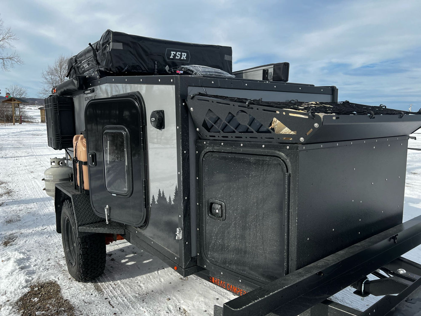 Boreas XT off-road camper, ideal for RV rental adventures! Ready for snow camping with its rooftop tent & rugged build.