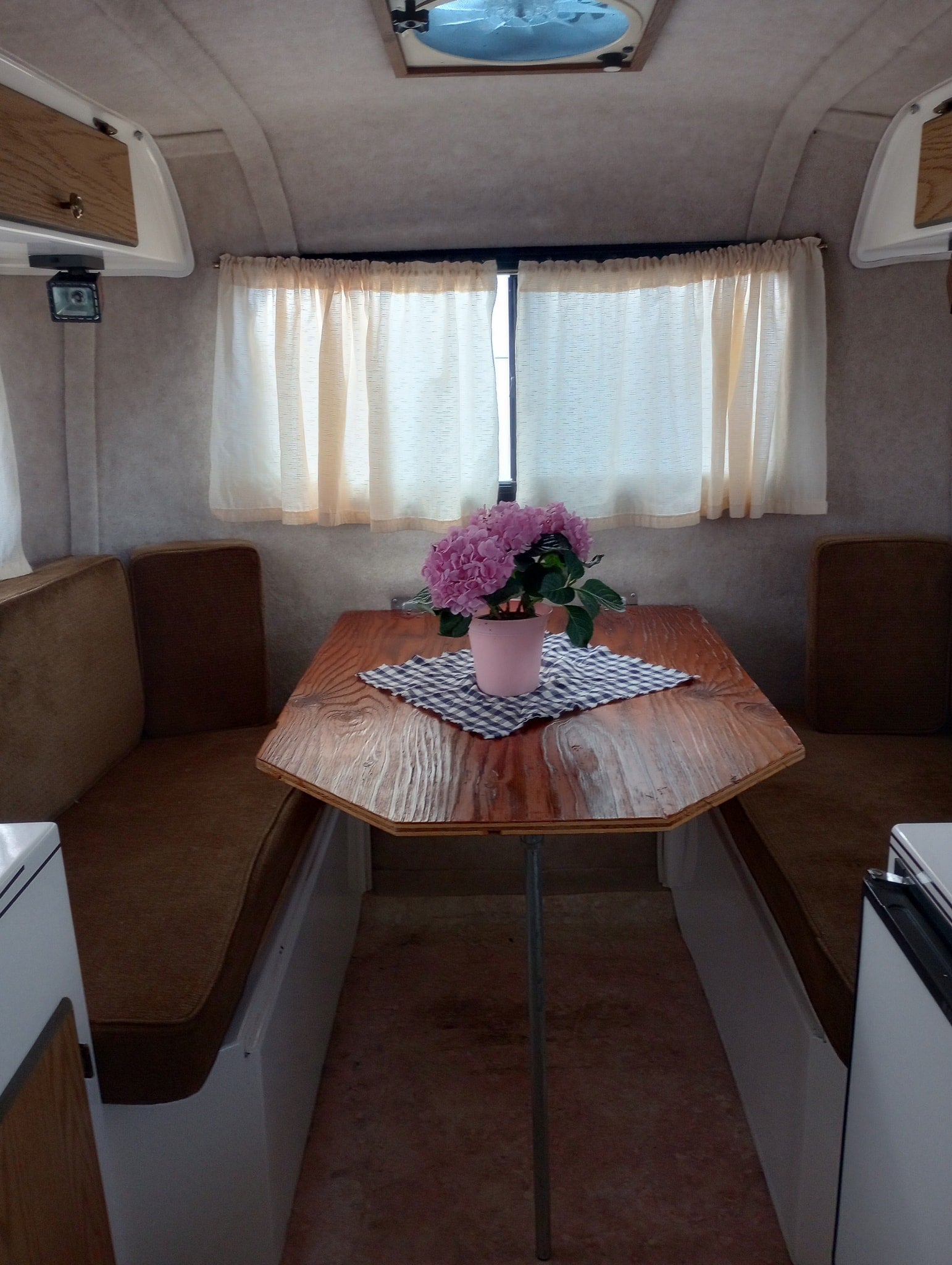 green field.|Interior view of a clean RV rental