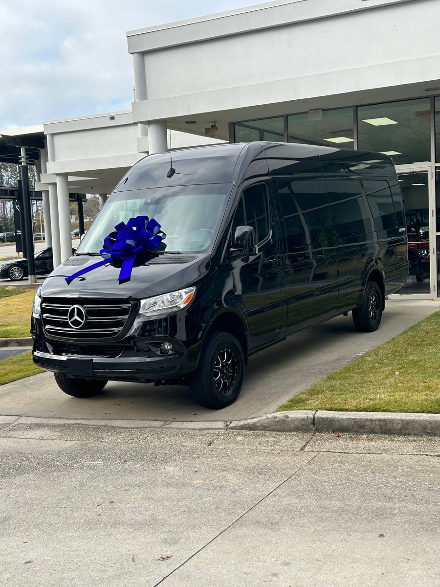 A sleek black Mercedes-Benz Sprinter van