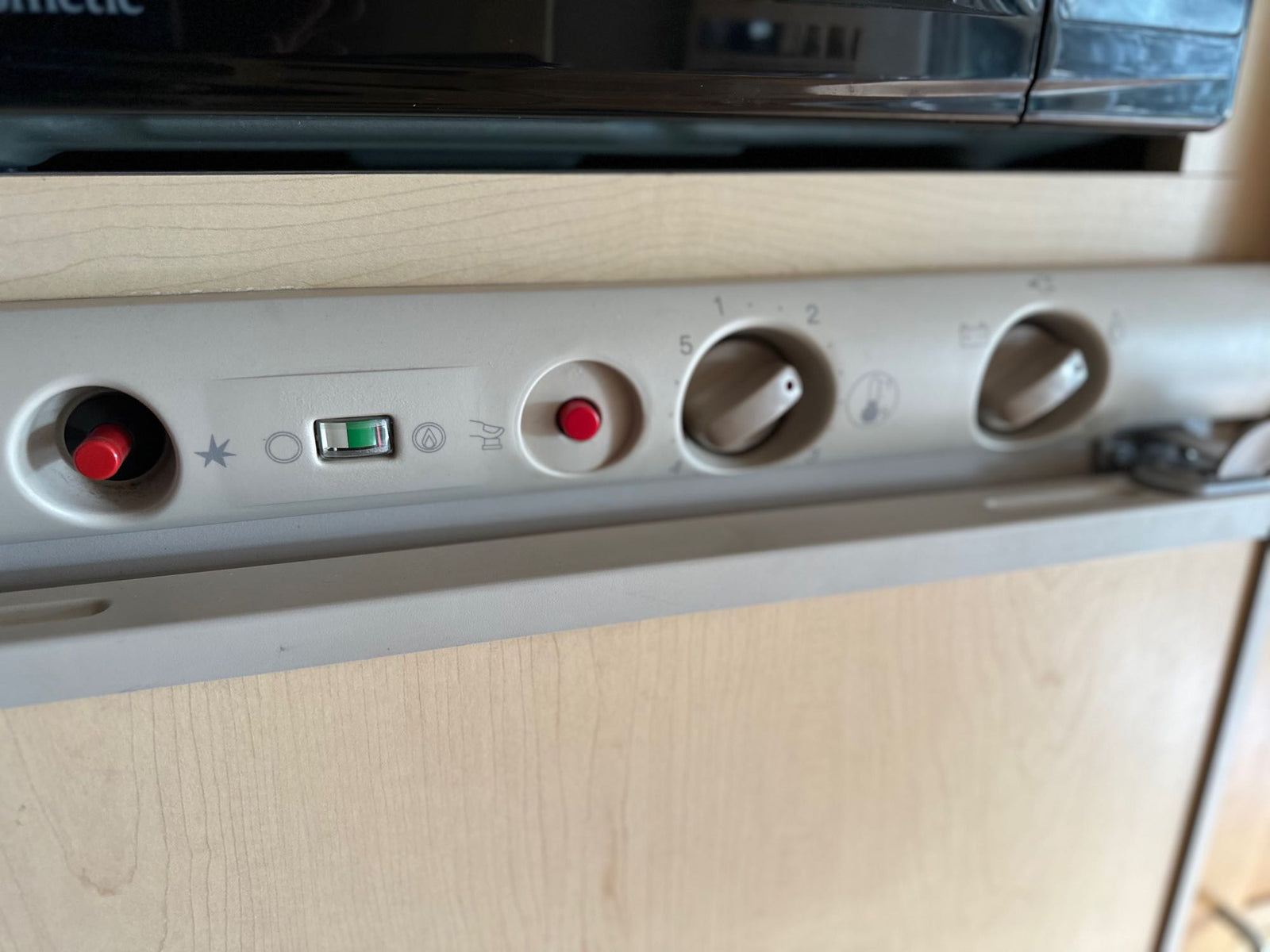 and mobile cooktop. Driver's cabin visible.|An RV rental's well-equipped kitchen with a stainless steel sink