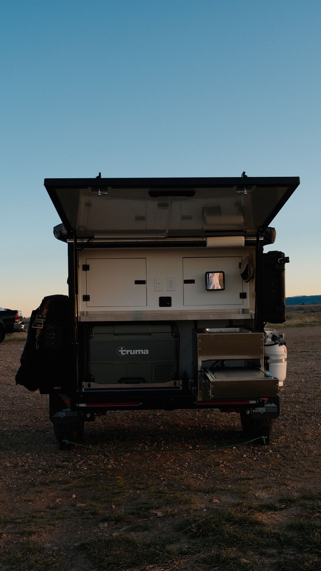 with a Truma fridge and pull-out stove. Consider this for your rv rental.|Cozy RV rental interior shows a clean bed
