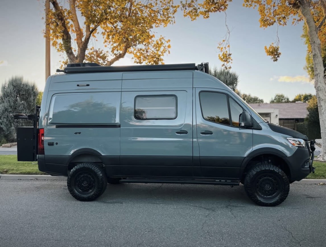 Explore with this gray Mercedes Sprinter camper van, modified with off-road tires & roof rack, ideal for an RV rental adventure. — photo 8