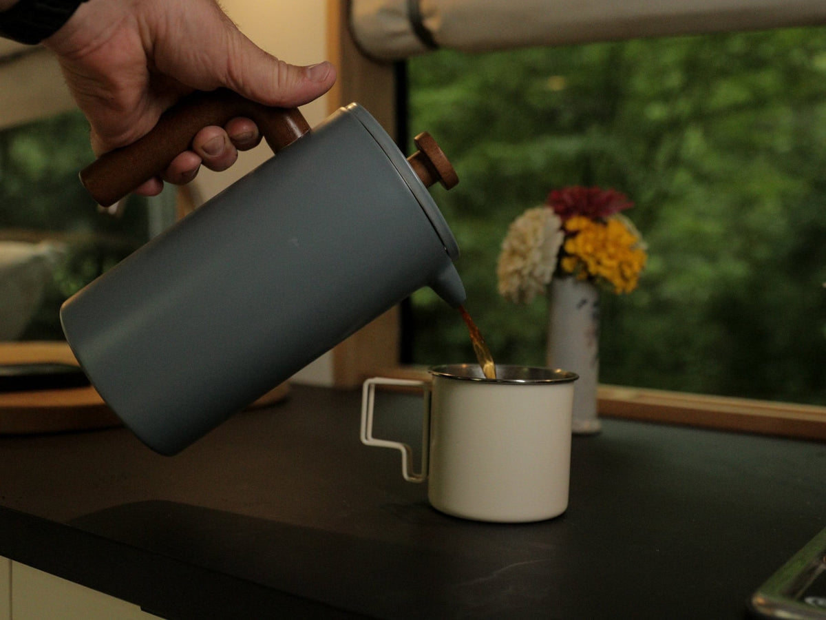 & stunning vineyard view. Ideal for travel & adventure.|Enjoy functional amenities in your RV rental. Filling a cooking pot with water in a camper van's compact kitchen.|Cooking on a gas stove inside an RV rental: a pot heats over a blue flame — photo 7