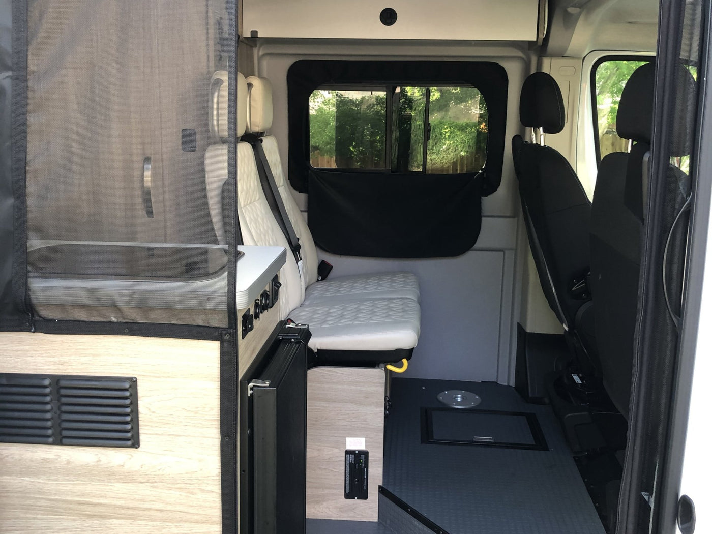 and a window with a scenic view. Ideal for road trips & adventures.|RV rental camper van interior showing kitchenette with stove — photo 7