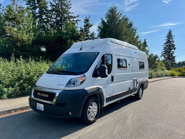 A white Ram rv rental camper van, parked outdoors and ready for your next travel adventure.