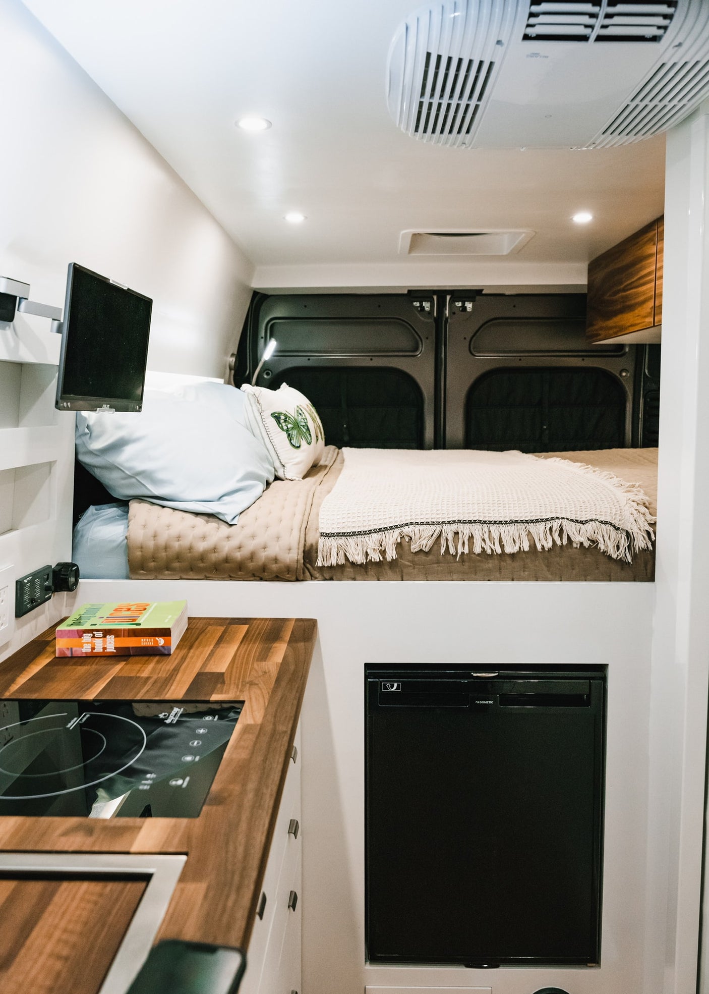 perfect for mobile living.|Inside a modern RV rental: a dad and child at the dining table