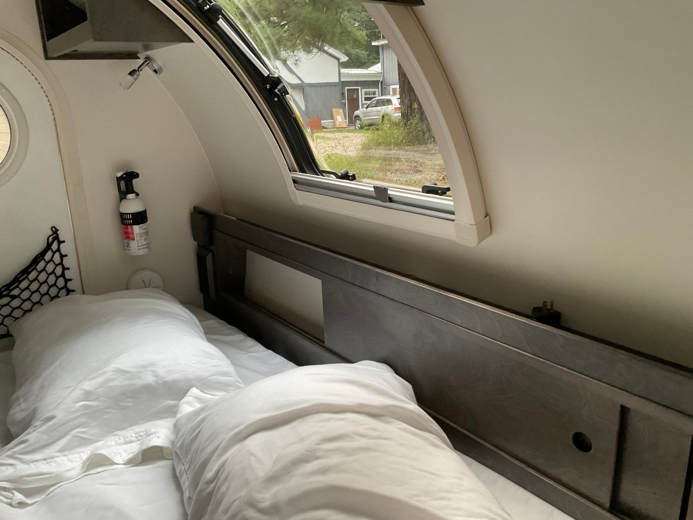 and an open archway to a vibrant green forest view.|Top-down view of an RV rental roof with a flexible solar panel