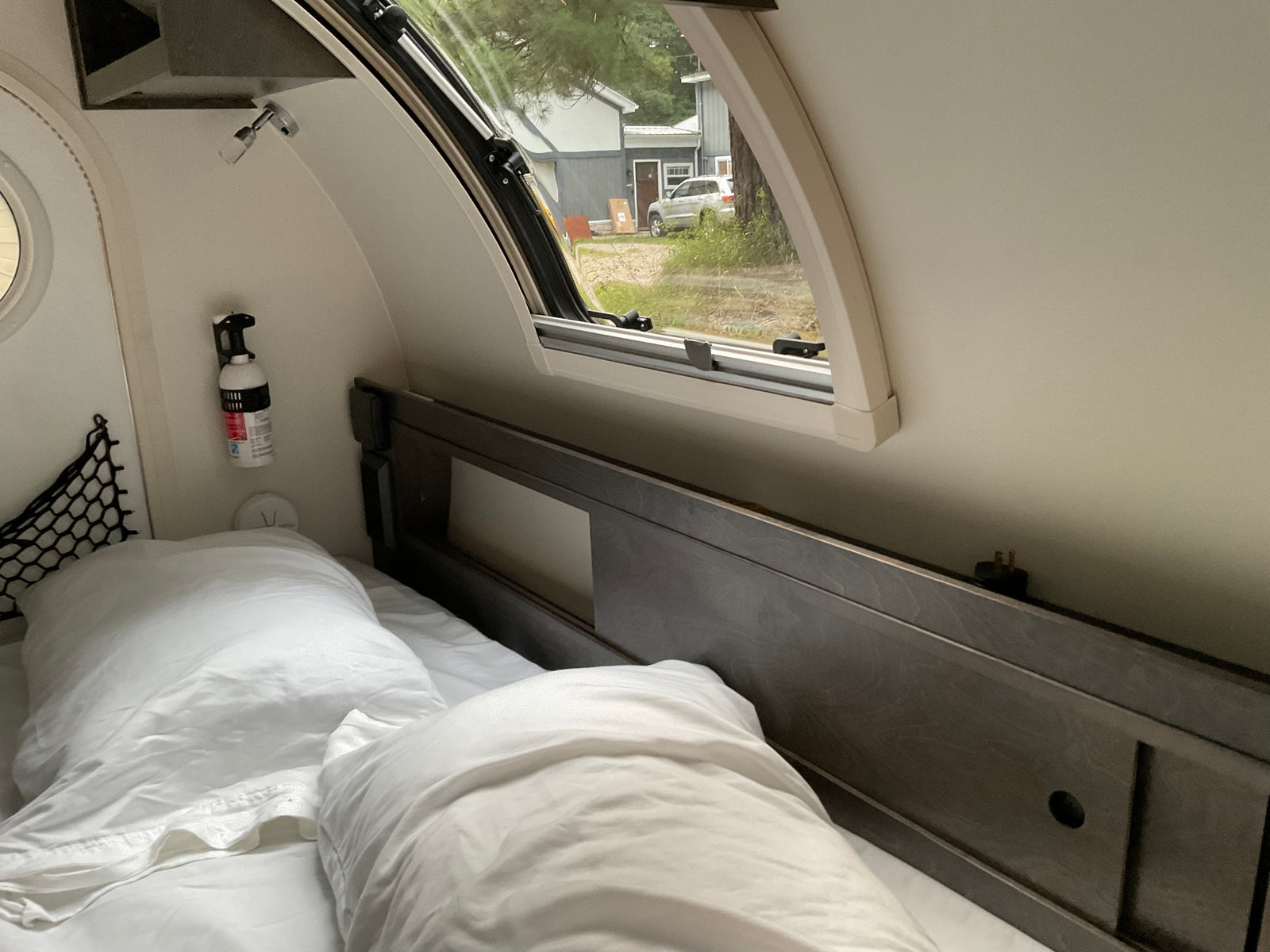 and an open archway to a vibrant green forest view.|Top-down view of an RV rental roof with a flexible solar panel