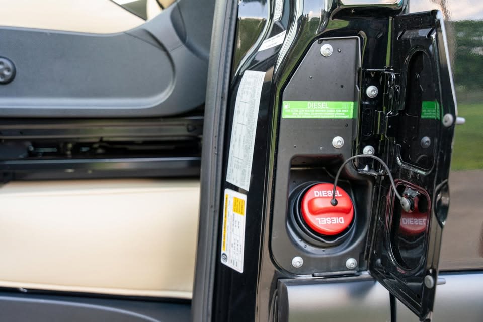 next to a compact door and kitchenette.|RV rental: Driver's perspective of a Mercedes-Benz interior