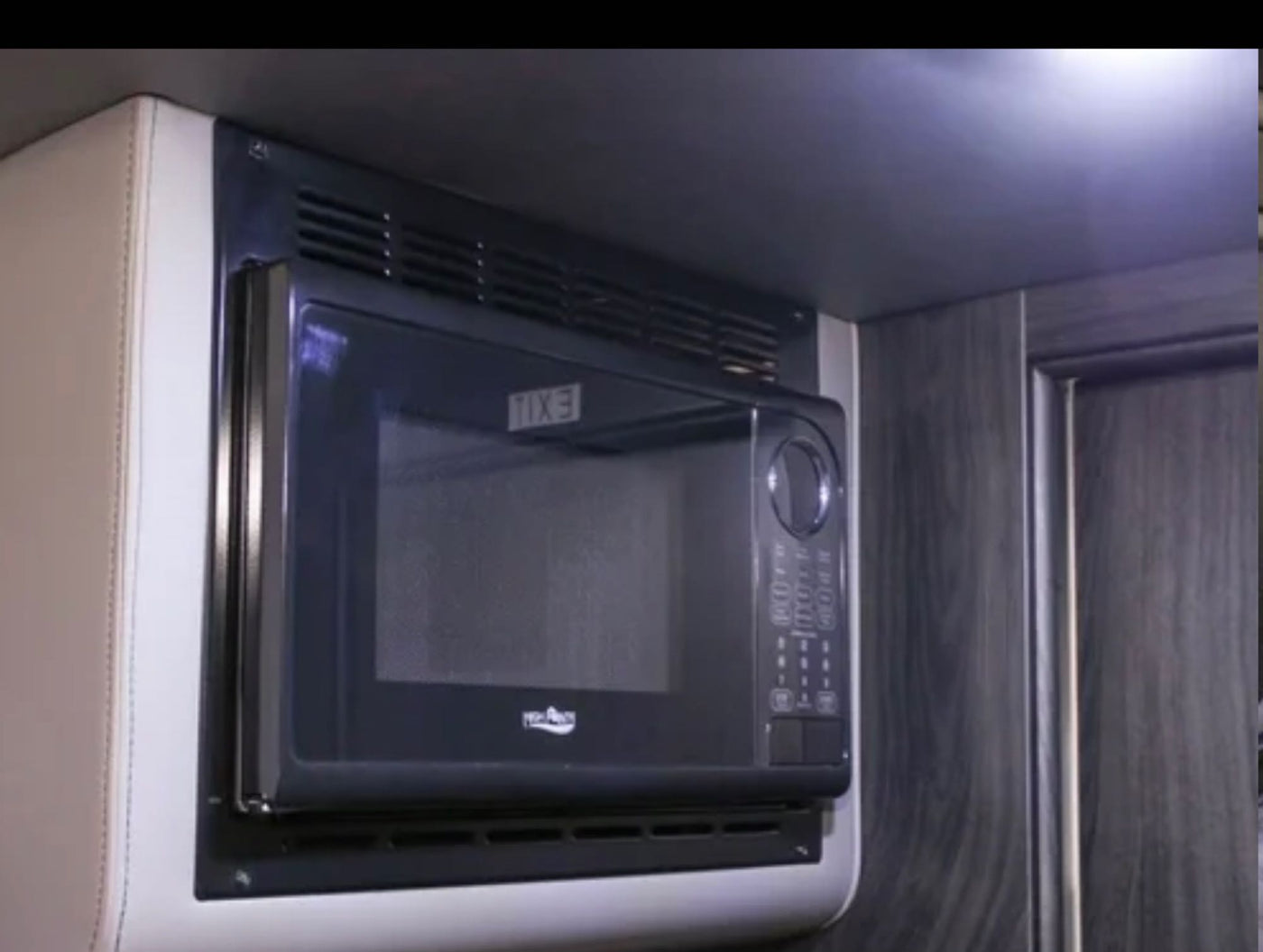 This image shows a sleek, compact microwave in an RV rental, providing convenient cooking. — photo 18