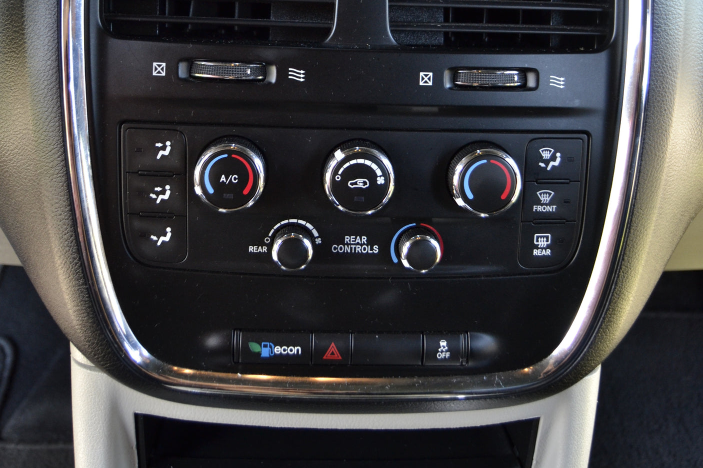 rv rental console: Vehicle climate control panel with front/rear A/C, fan, and temperature knobs, plus defroster and economy mode buttons.