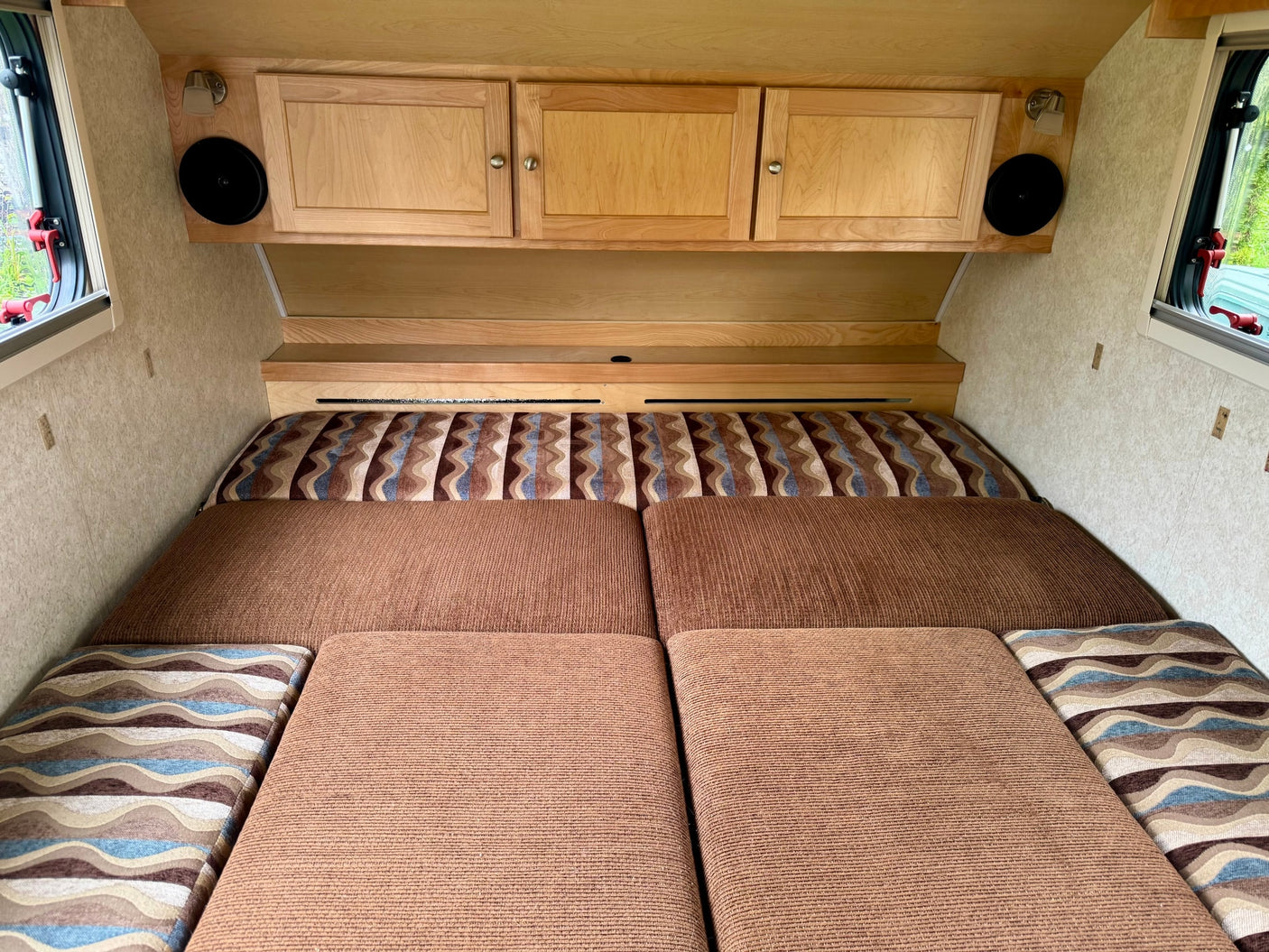 ready for travel.|Cozy RV rental interior featuring a comfortable bed