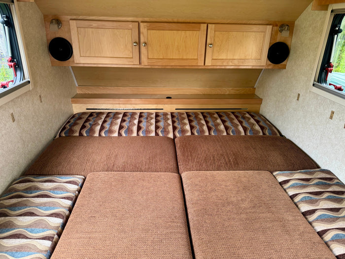 ready for travel.|Cozy RV rental interior featuring a comfortable bed