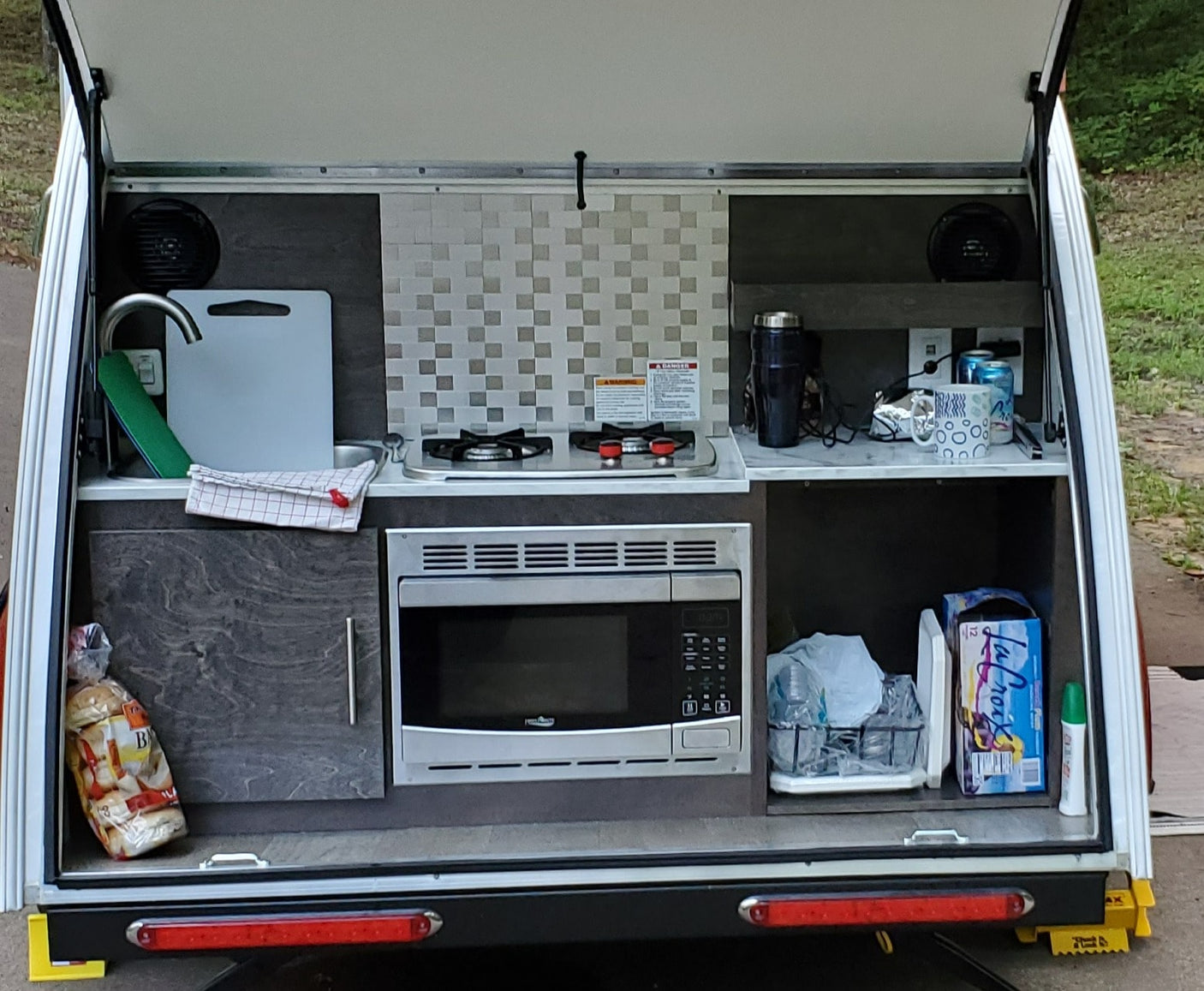 ready for a travel adventure.|This RV rental's rear galley features a functional outdoor kitchen with sink