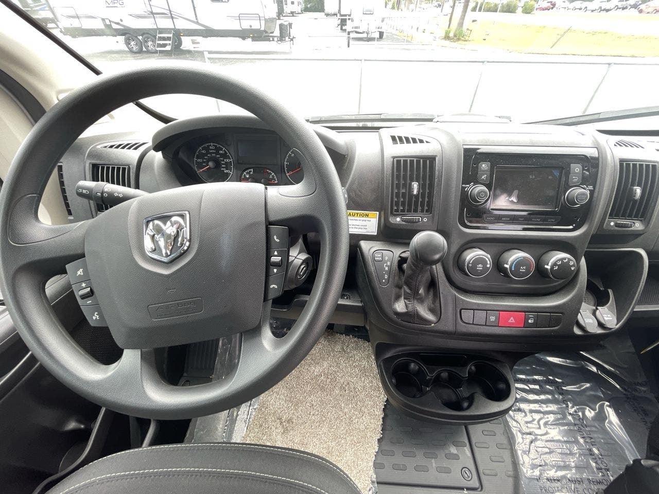parked on concrete. Consider for rv rental.|Cockpit of an RV rental van