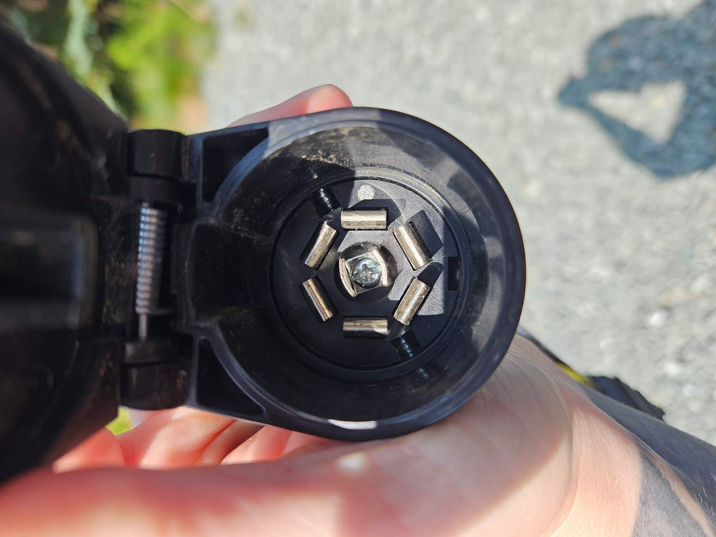 Close-up of a 7-pin RV electrical connector, crucial for any RV rental. Ensures power for trailer lights & brakes.