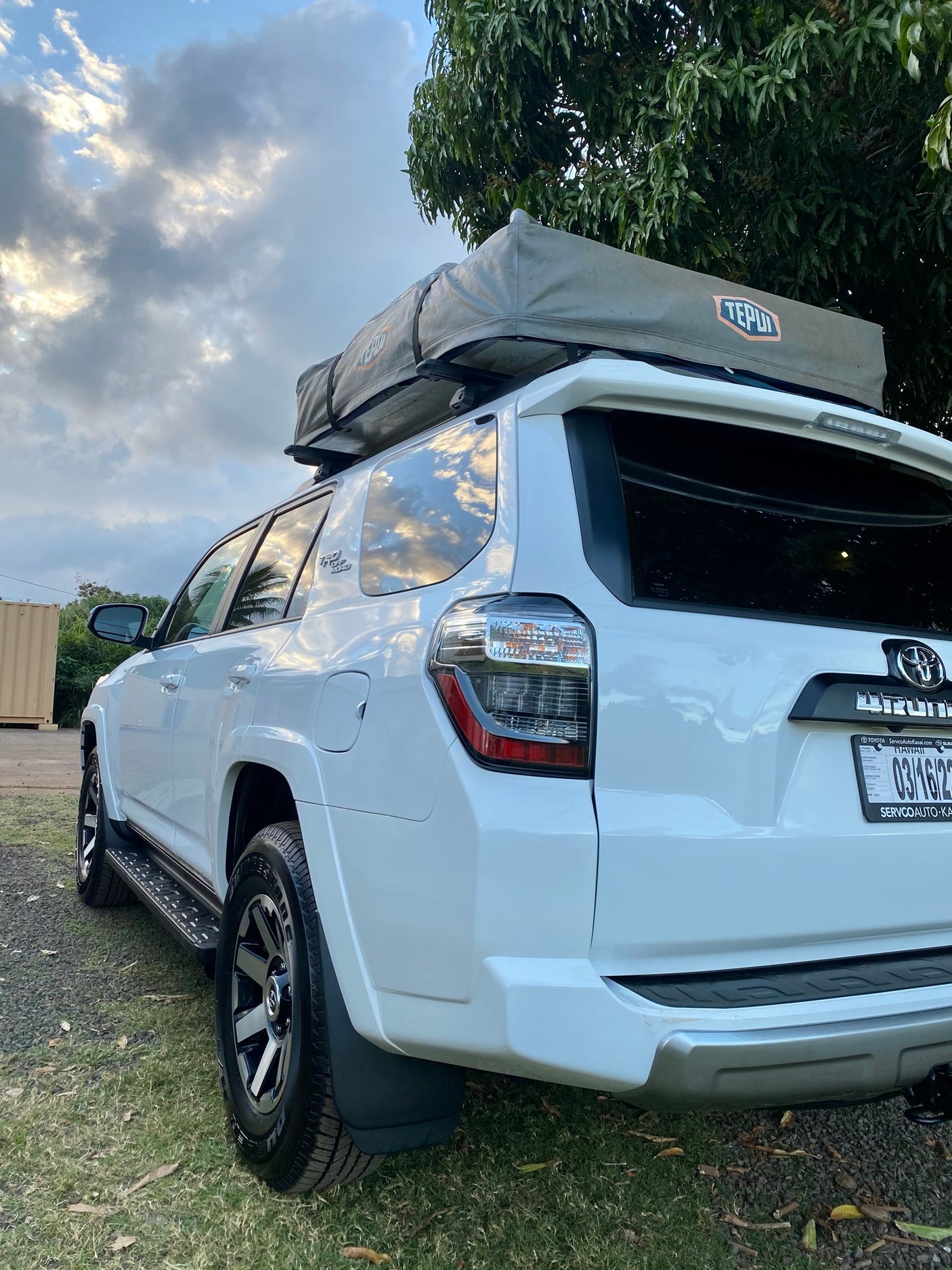 White Toyota 4Runner SUV equipped with a rooftop tent, offering an RV rental alternative for outdoor adventures.