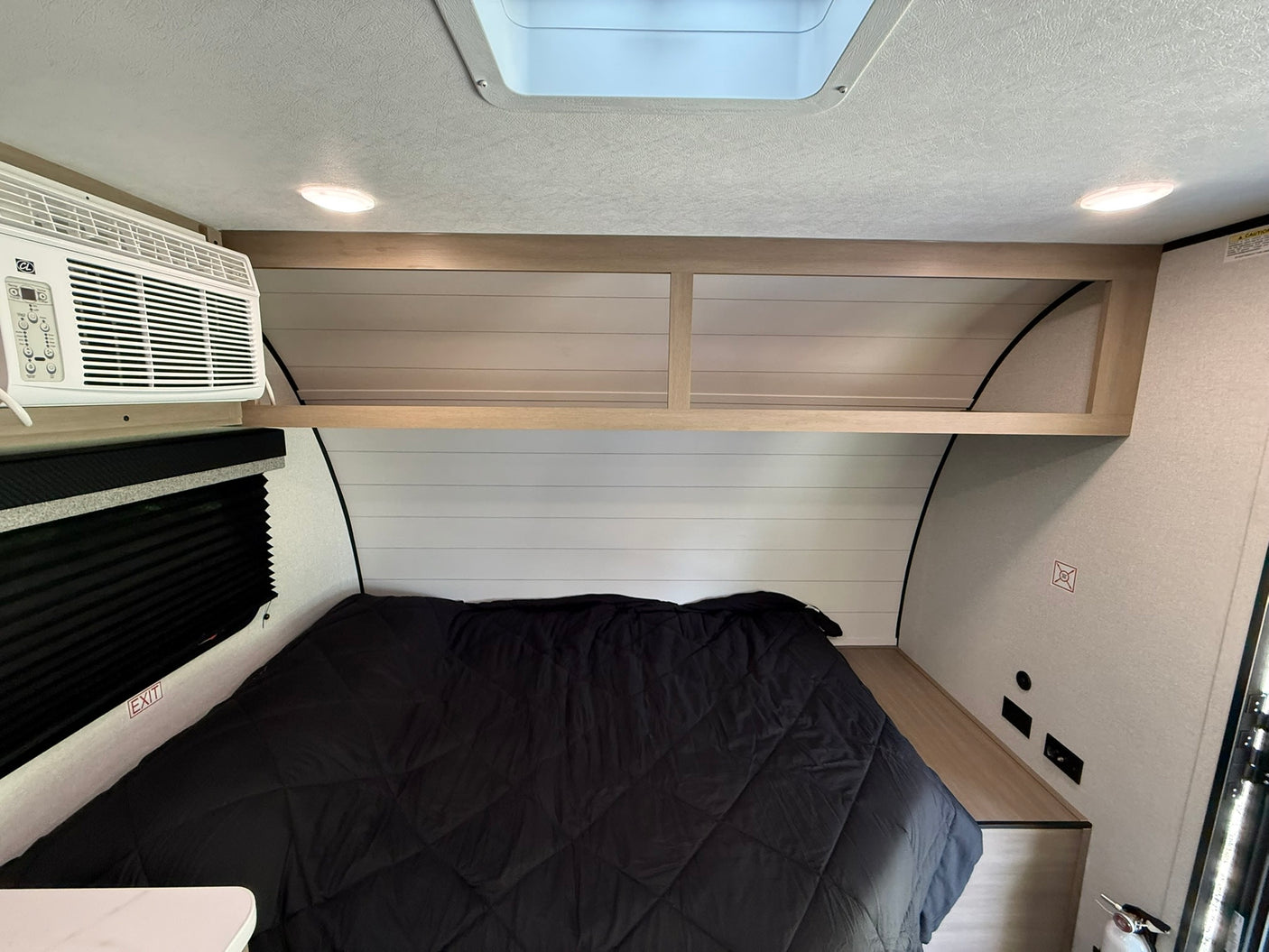 ready for your travel provisions.|Inside an RV rental: two bunk beds with gray bedding