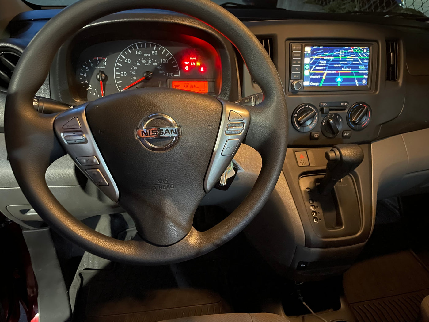 Nissan RV rental interior showing dashboard with 5219.3 miles, steering wheel, and navigation screen. — photo 6