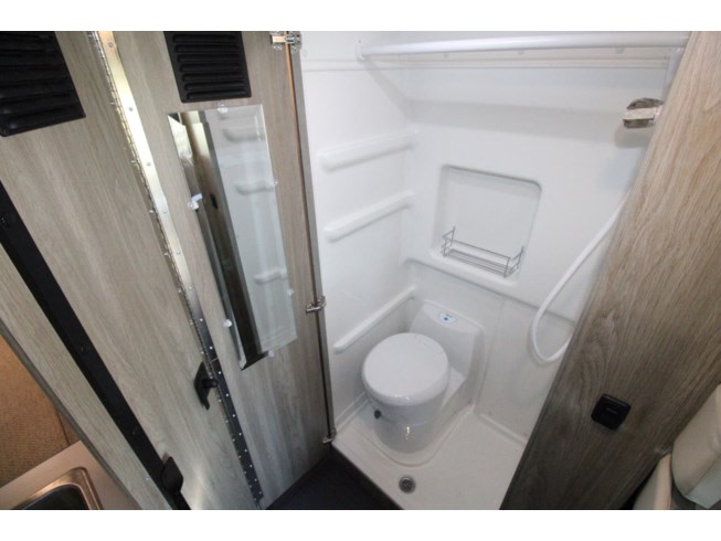 ready for adventure or camping.|RV rental pop-top interior: a clean sleeping area with mattress covered in protective plastic