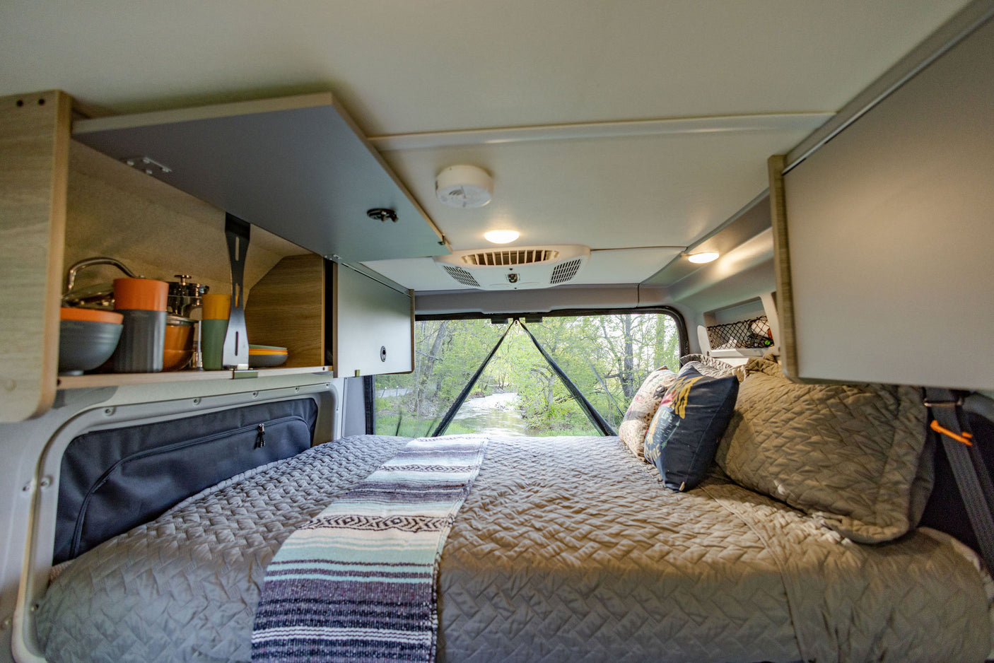 and dining space. Ideal rv rental for mobile adventures.|An RV rental's clever interior. From the comfy bed