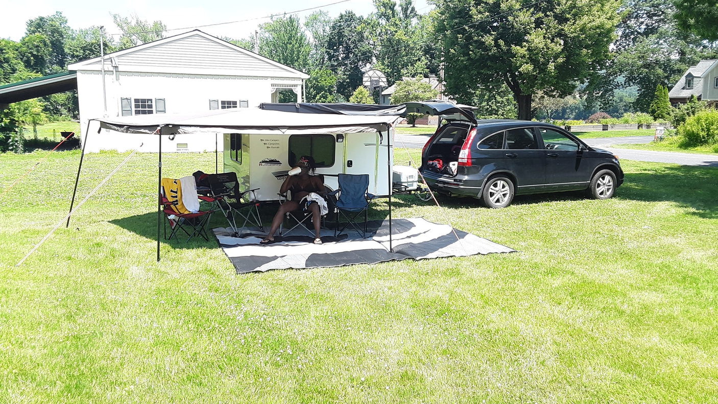 Relaxing by an RV rental camper hooked to an SUV