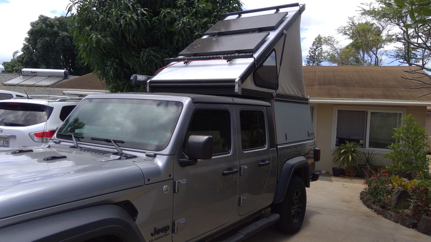 an excellent RV rental option for outdoor adventures and overlanding.|Silver Jeep Gladiator with pop-up camper & solar panels — photo 3