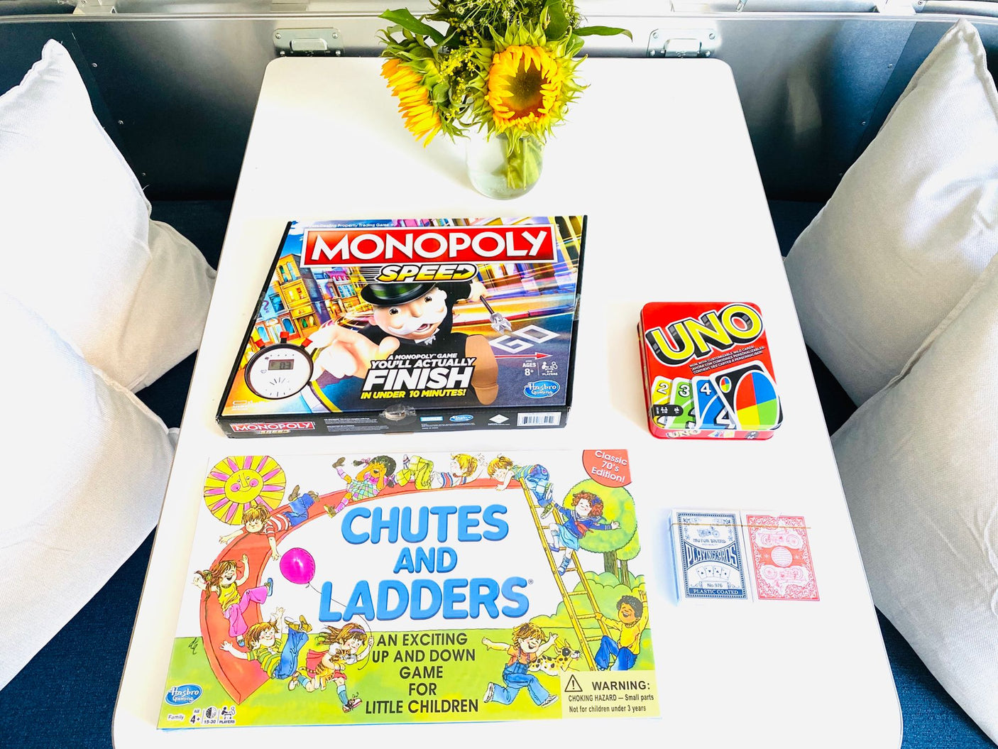 This RV rental offers a table of entertainment, including Monopoly Speed, Chutes and Ladders, UNO, and playing cards for family fun.
