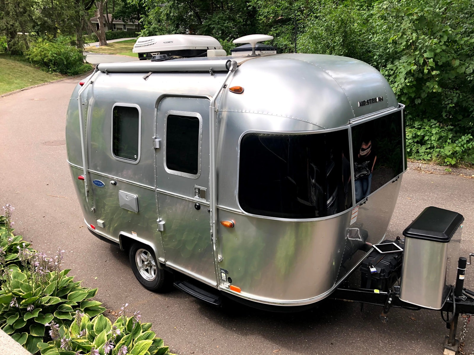 This shiny Airstream Sport travel trailer, equipped with a Dometic AC, is perfect for your next RV rental and outdoor adventure.