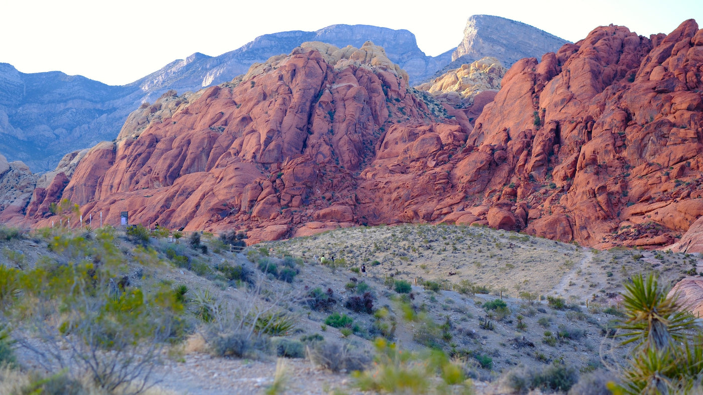 Scenic Red Rock Canyon: iconic red mountains, desert trails, and hikers on a path. Enjoy the views with an RV rental adventure. — photo 10