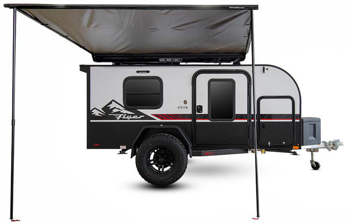 Explore the wild with this rugged black & grey Flyer Pursue off-road travel trailer, shown with an extended awning, ready for RV rental.