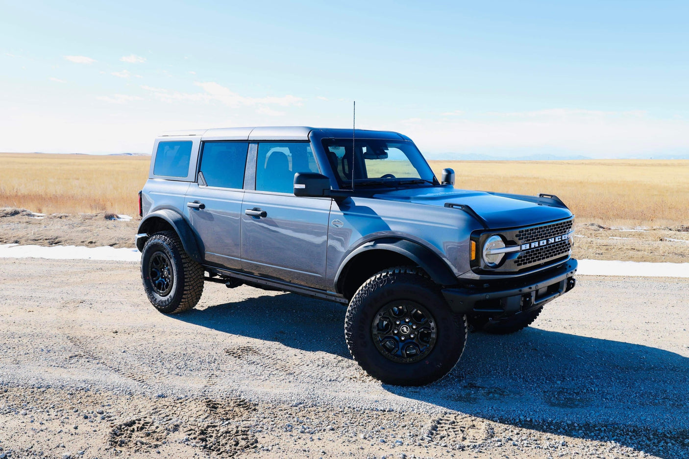 Rugged gray Ford Bronco SUV on a dirt road, ideal for adventure. Consider this dynamic vehicle for your rv rental needs.
