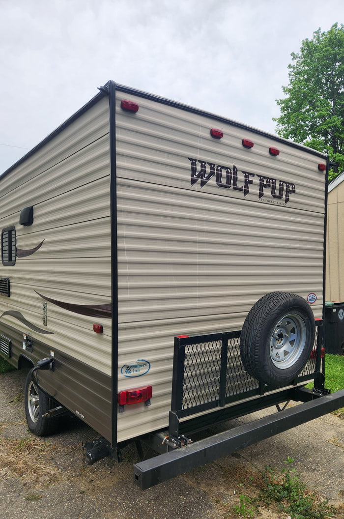 and a small dinette area.|Cozy rv rental bedroom: patterned bed